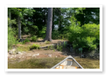 A canoe heading for the shore of Duncan Lake